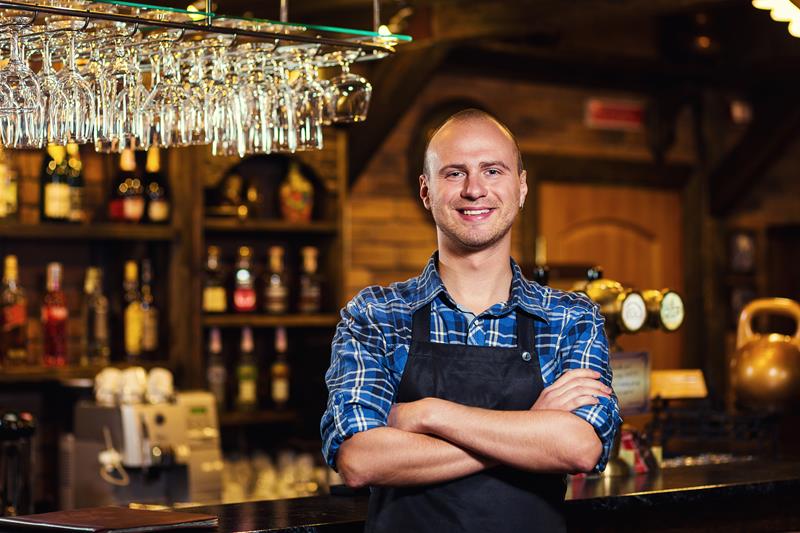 Barman at work in pub,