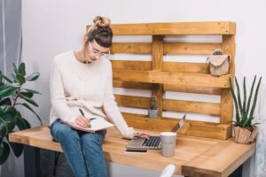 A young woman preparing for a job interview by making notes