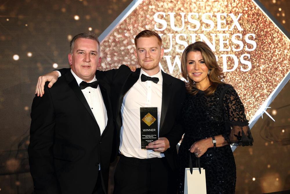 Sam Hickman posing with Natasha Kaplinsky and Daniel from Nordell Plastics at the Sussex Business Awards in 2022.