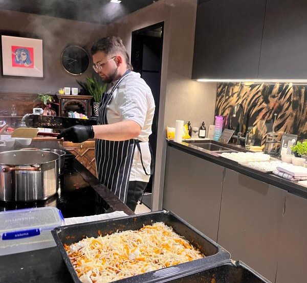 Private chef cooking over a hob in a domestic kitchen